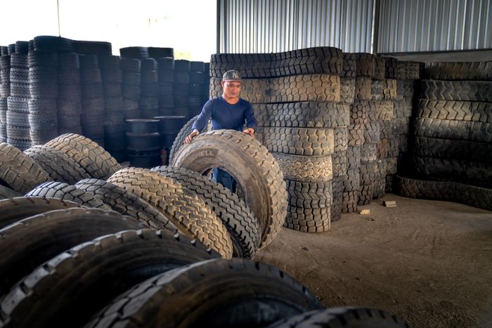 Large commercial vehicle tyre being handled in a warehouse